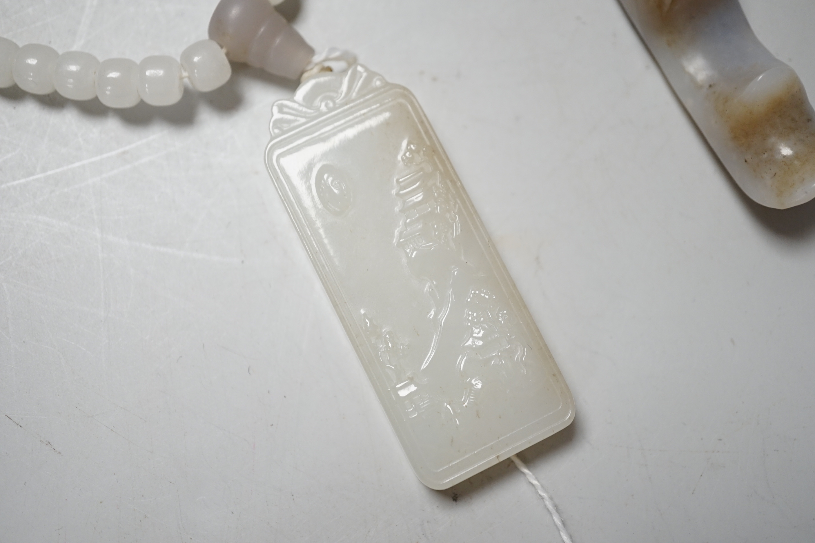 A Chinese white jade pendant and a jade brush rest